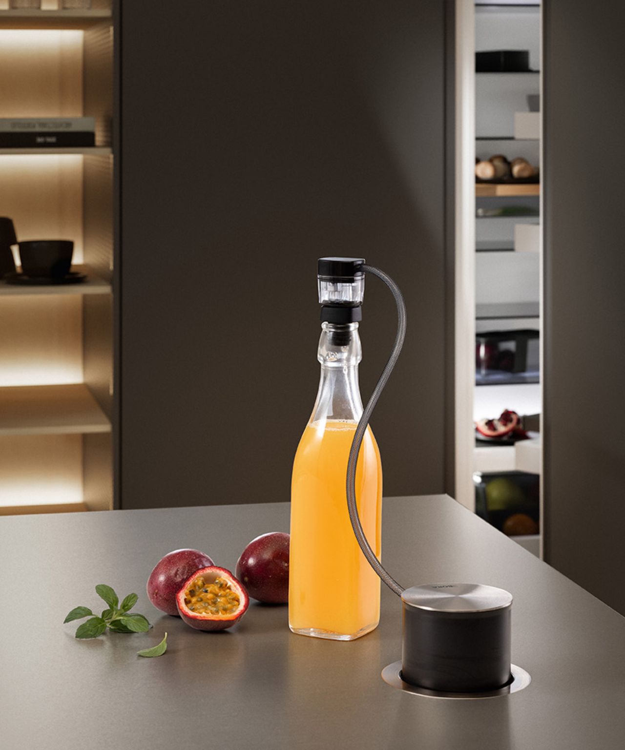 Bora QVac inset into kitchen island showing it in use on bottle and pack of food