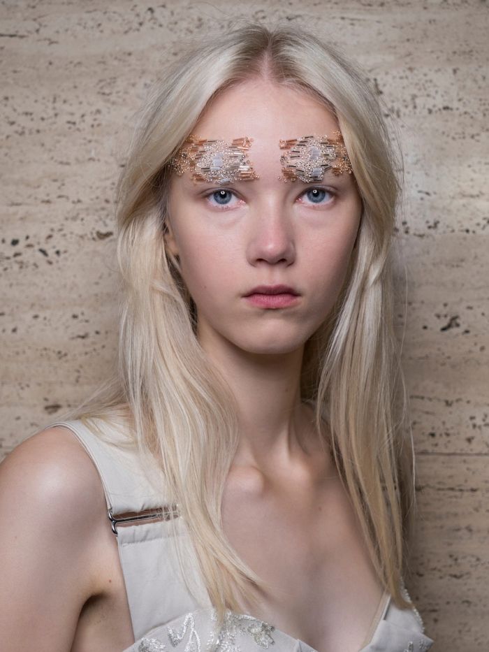 A model backstage at Simone Rocha S/S 27 with beaded brows