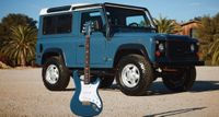 PRS Silver Sky Defender in front of a matching Defender 4x4.