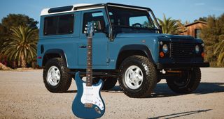 PRS Silver Sky Defender in front of a matching Defender 4x4.