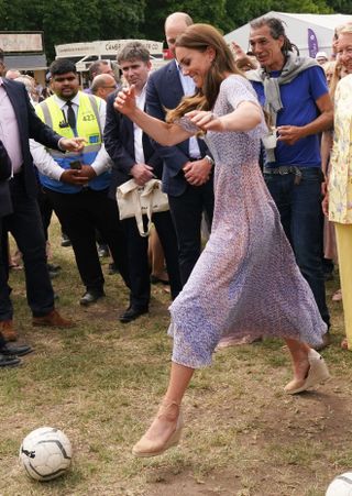 Kate Middleton football - Catherine, Duchess of Cambridge takes a kick of a ball as she attends Cambridgeshire County Day at Newmarket Racecourse during an official visit to Cambridgeshire on June 23, 2022 in Cambridge, England.