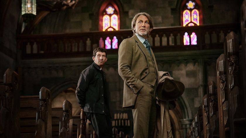 Josh O&#039;Connor&#039;s unnamed priest standing in a church behind Daniel Craig&#039;s Benoit Blanc in Knives Out 3