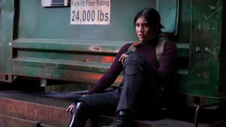 Maya Lopez sits on the edge of a train carriage in Marvel Studios' Echo TV show