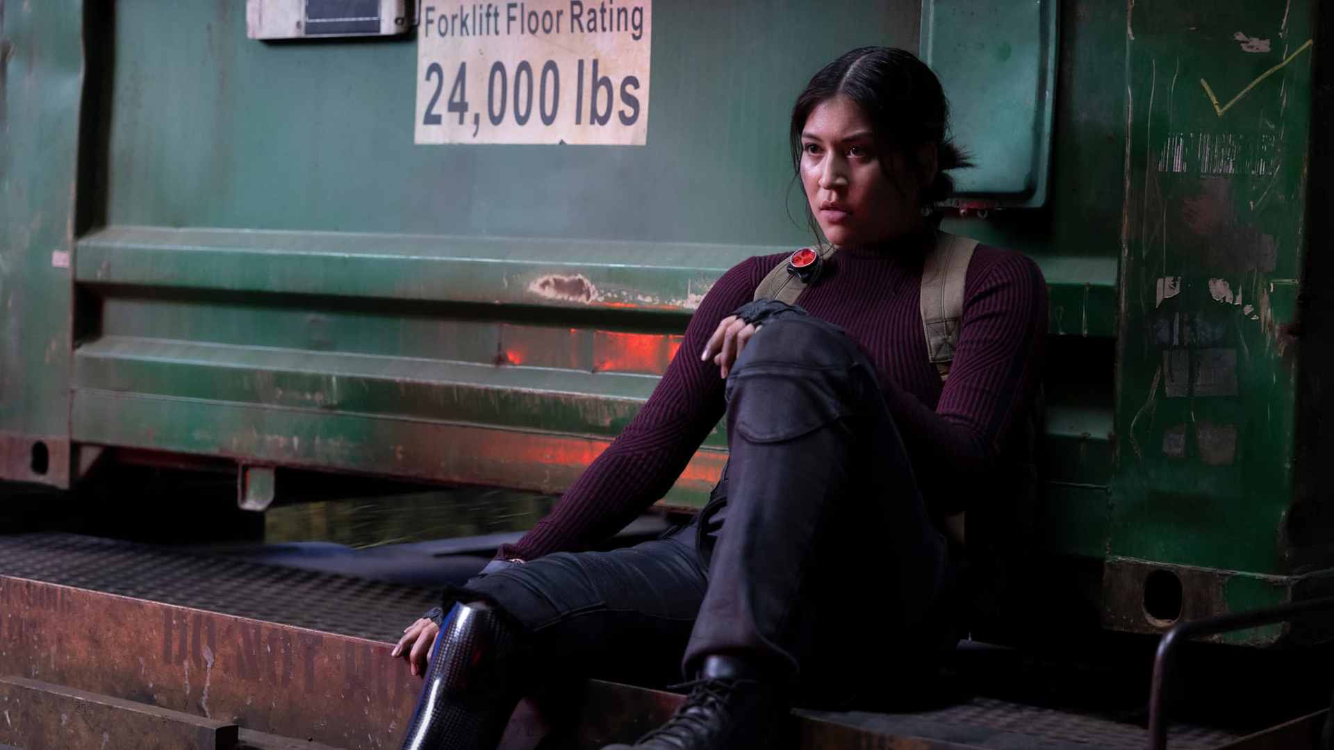 Maya Lopez sits on the edge of a train carriage in Marvel Studios' Echo TV show