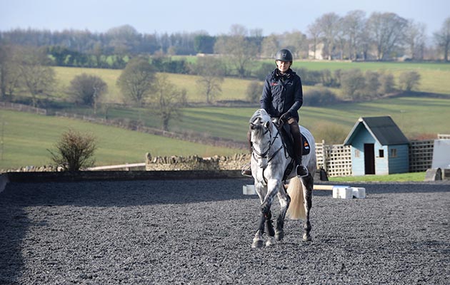 Kathryn Robinson riding Castello 236 (Bambi) and Giovanni Ugolotti riding Penhills Celtic Rolex (Donald) in the All-weather arena at Giovanni Ugolotti and Kathryn Robinson stables; Cranford Stud Eventing is based at Empshill Farm (Owned by Julie Tew) in the village of Farmington near Cheltenham in the county of Gloucestershire in the UK on the 26th January 2018