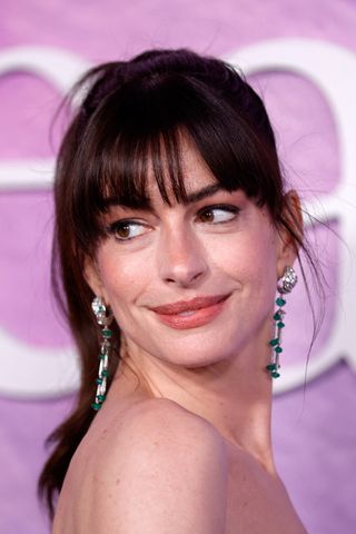 Anne Hathaway is pictured with a statement fringe and her hair in a ponytail at the Prime Video's "The Idea of You" premiere at Jazz at Lincoln Center in New York City on April 29, 2024.