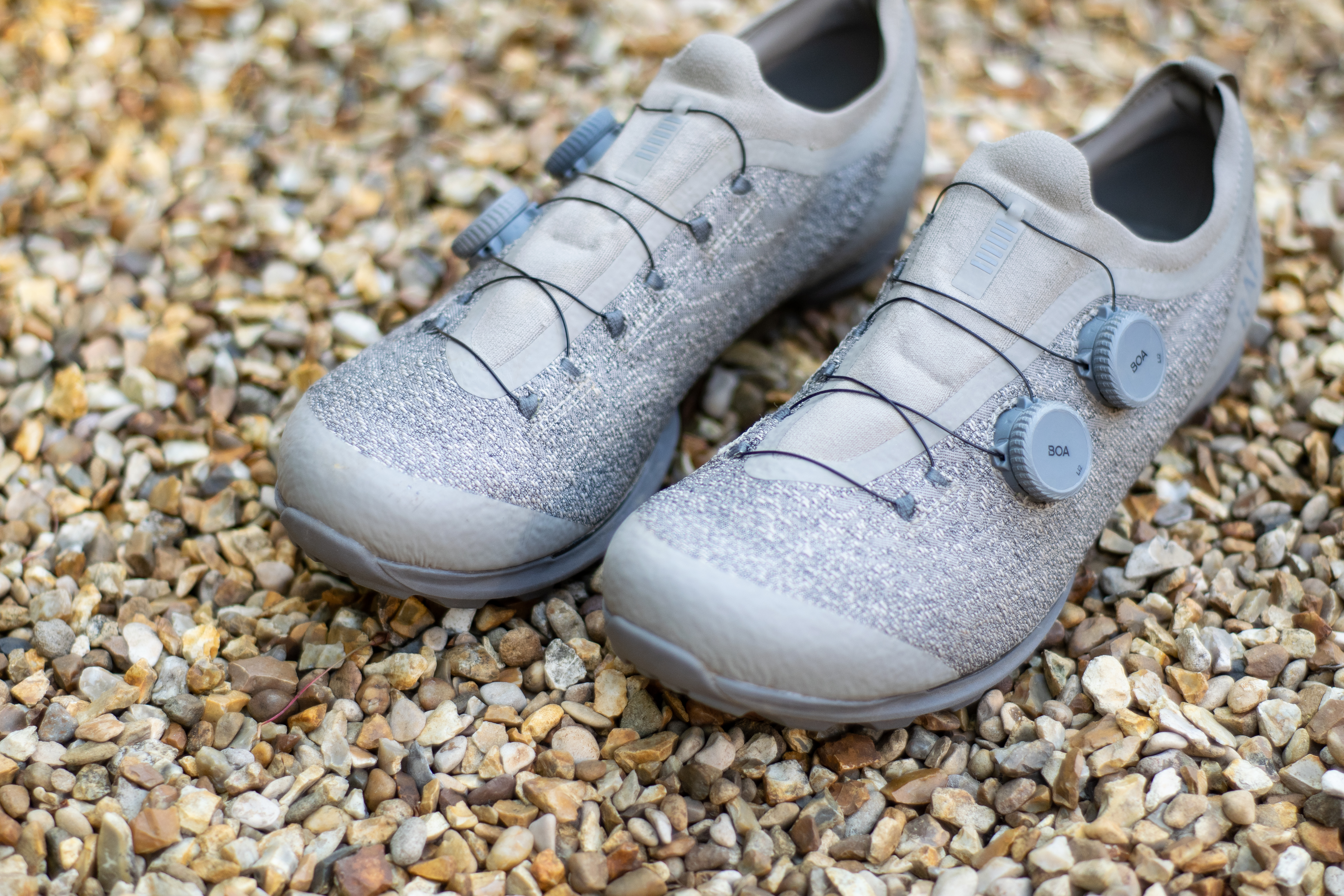 A pair of Rapha Pro Team Gravel shoes on some gravel