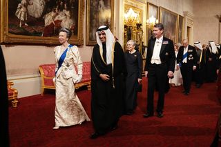 Princess Anne wears a brocade satin gown and tiara while arriving at the Qatari State Banquet at Buckingham Palace