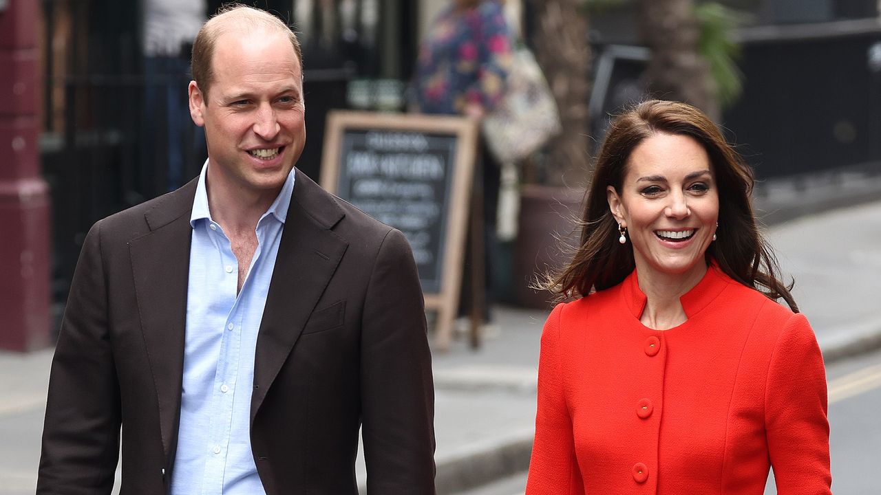 Prince William, wearing a suit, and Catherine, Princess of Wales, wearing a red coat, arrive at the Dog &amp; Duck pub during their visit to Soho on May 04, 2023