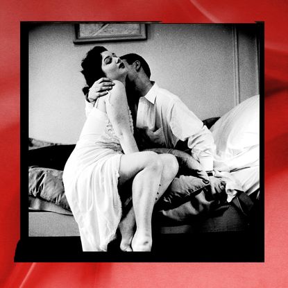 heterosexual couple kissing with red background 