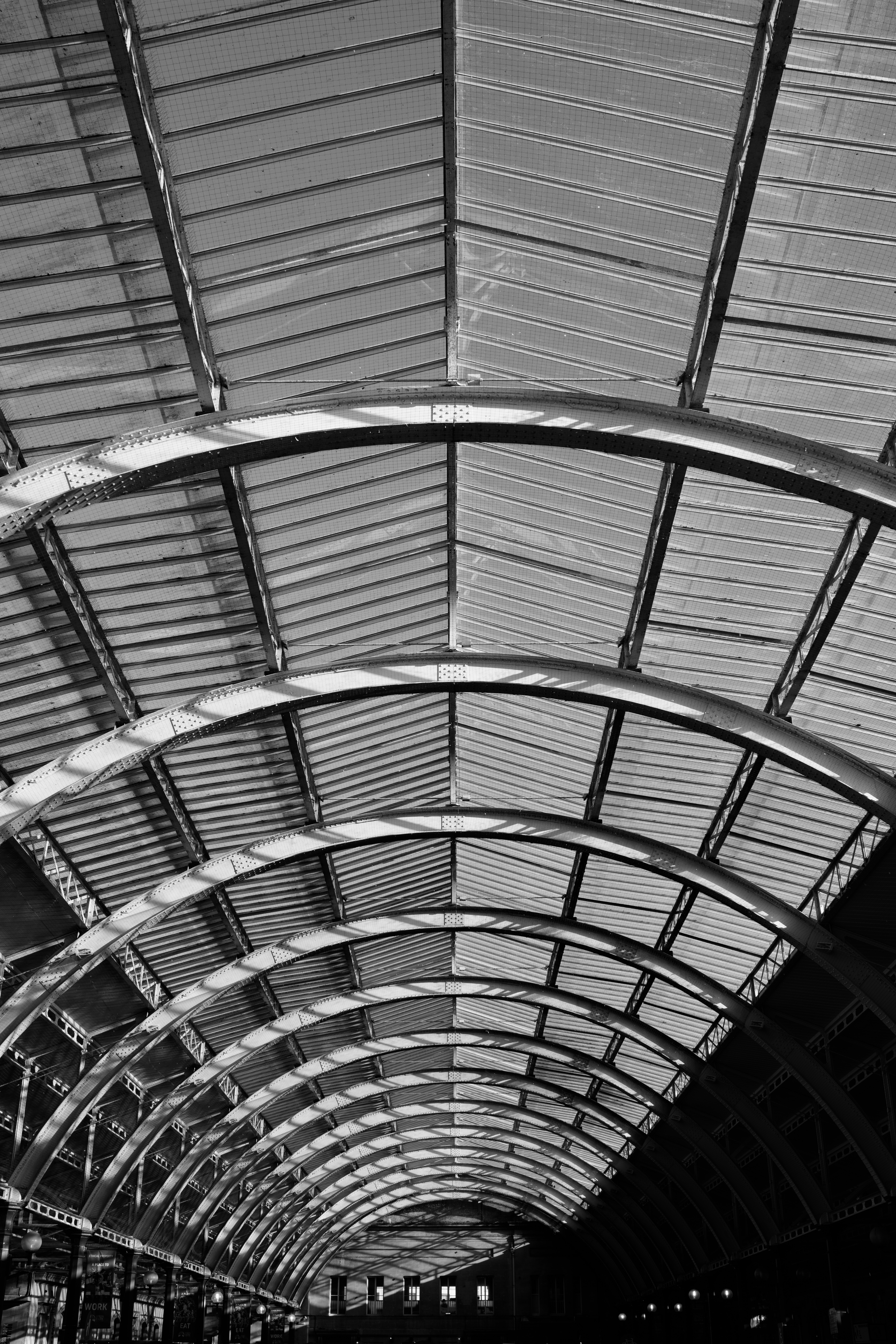 A black and white photo of a vaulted metal roof