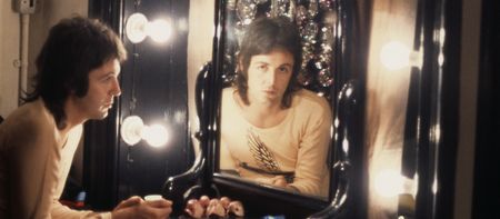 Paul McCartney in 1973 looking through a mirror (from Man on the Run documentary)