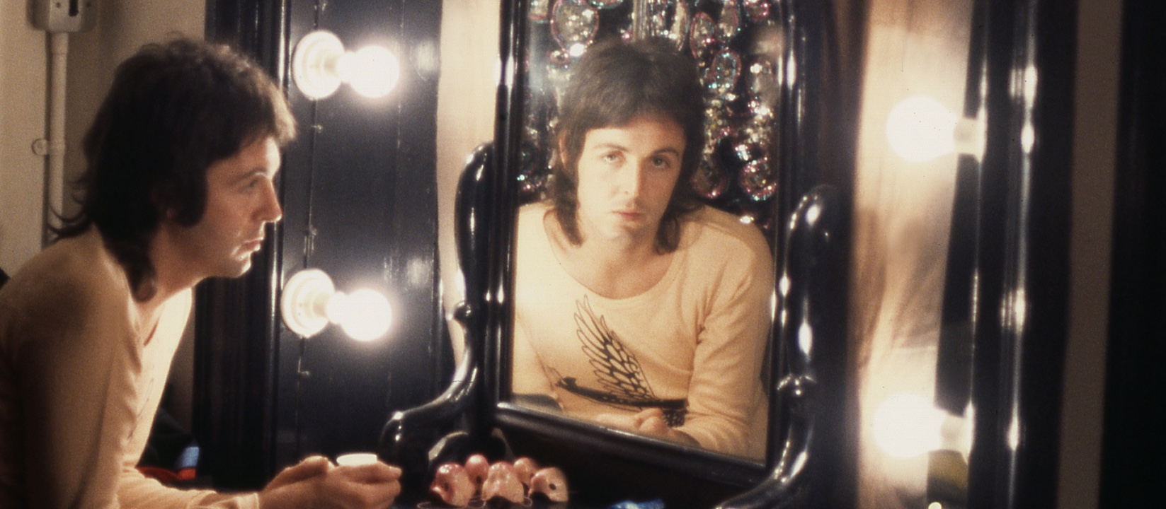 Paul McCartney in 1973 looking through a mirror (from Man on the Run documentary)