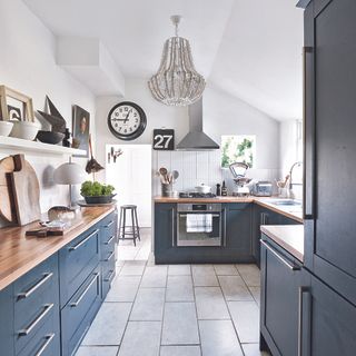 kitchen with grey drawers and chandelier