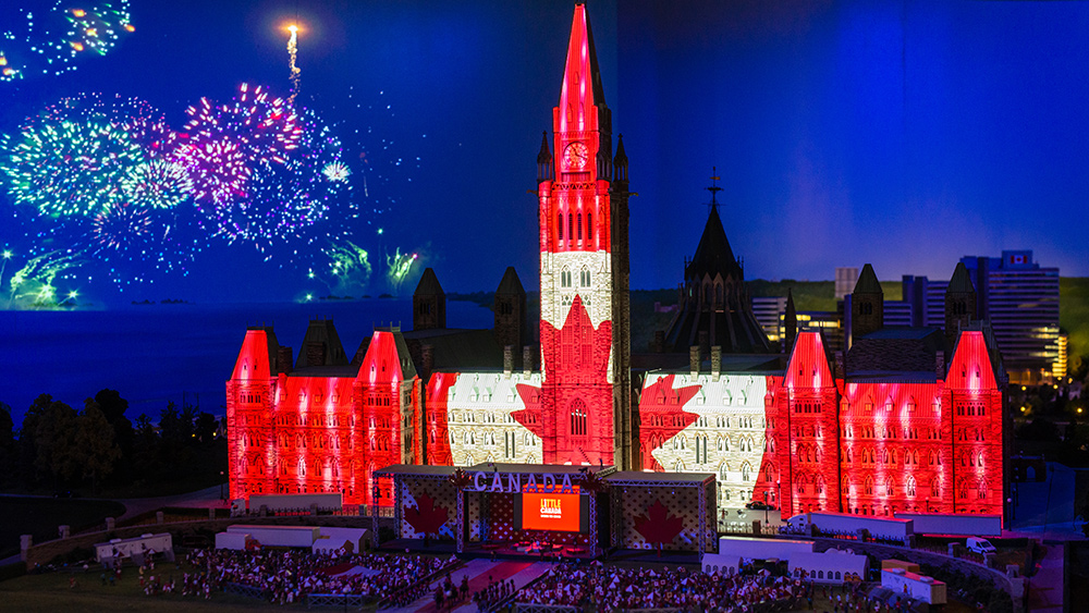 A miniaturised Parliament Building is projection mapped with the Canadian flag at Toronto’s Little Canada