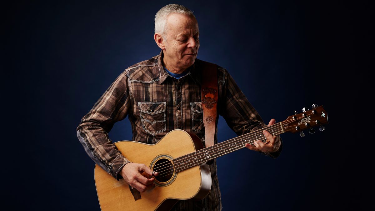 Tommy Emmanuel plays his acoustic guitar