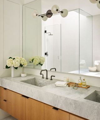 midcentury bathroom with wooden vanity unit and large mirror