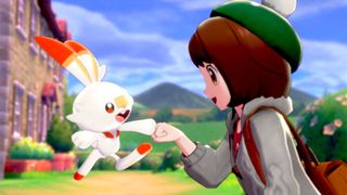 best Pokemon games: Pokemon trainer bumps fists with a Scorbunny