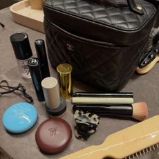 two images, one of a Chanel makeup bag and assorted makeup, the other of Marci Hirshleifer Penn in a burnt orange jacket