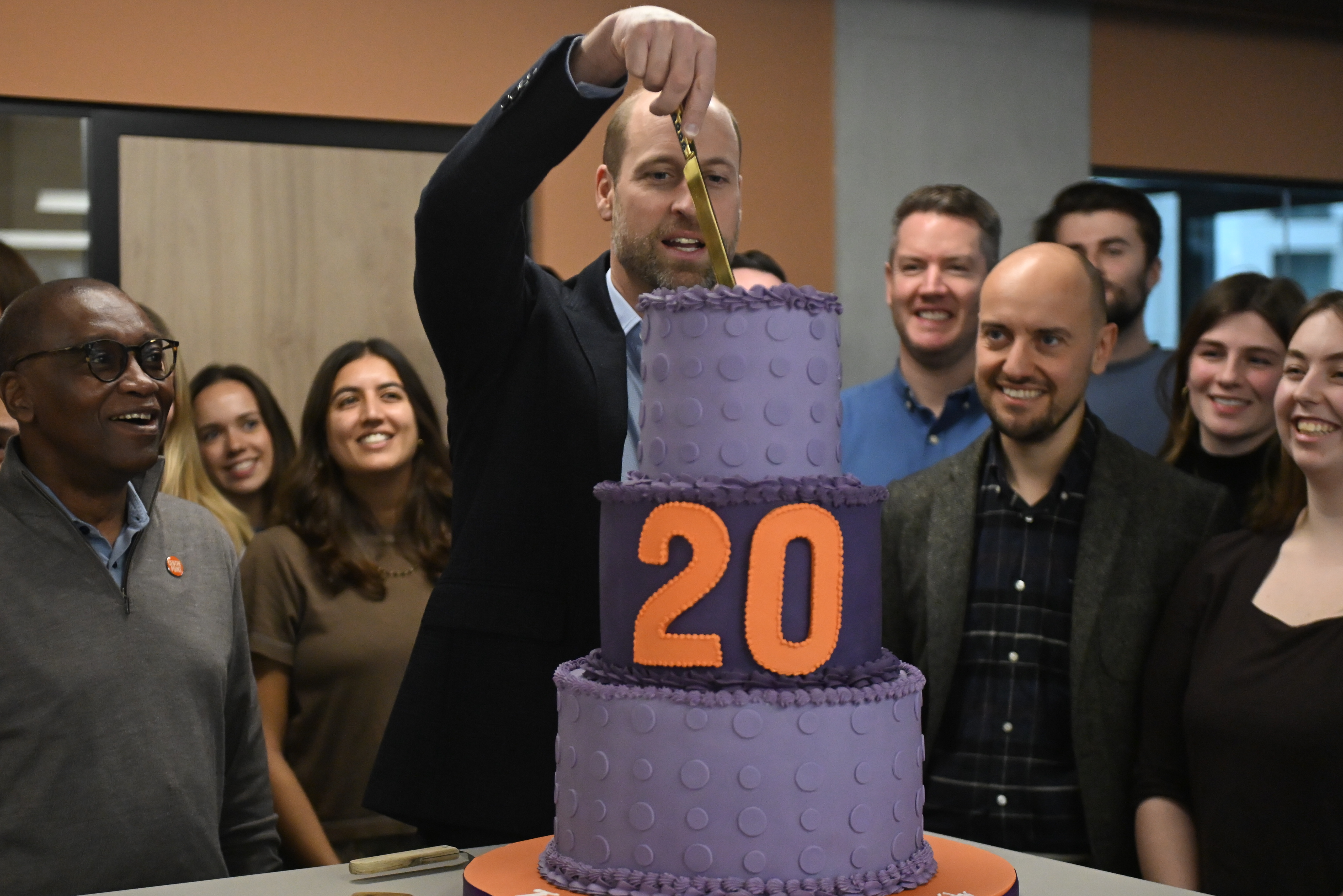 Prince William cutting a cake