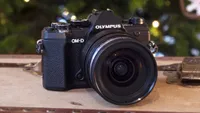 Front shot of the Olympus OM-D E-M5 Mark III on front of a Christmas tree