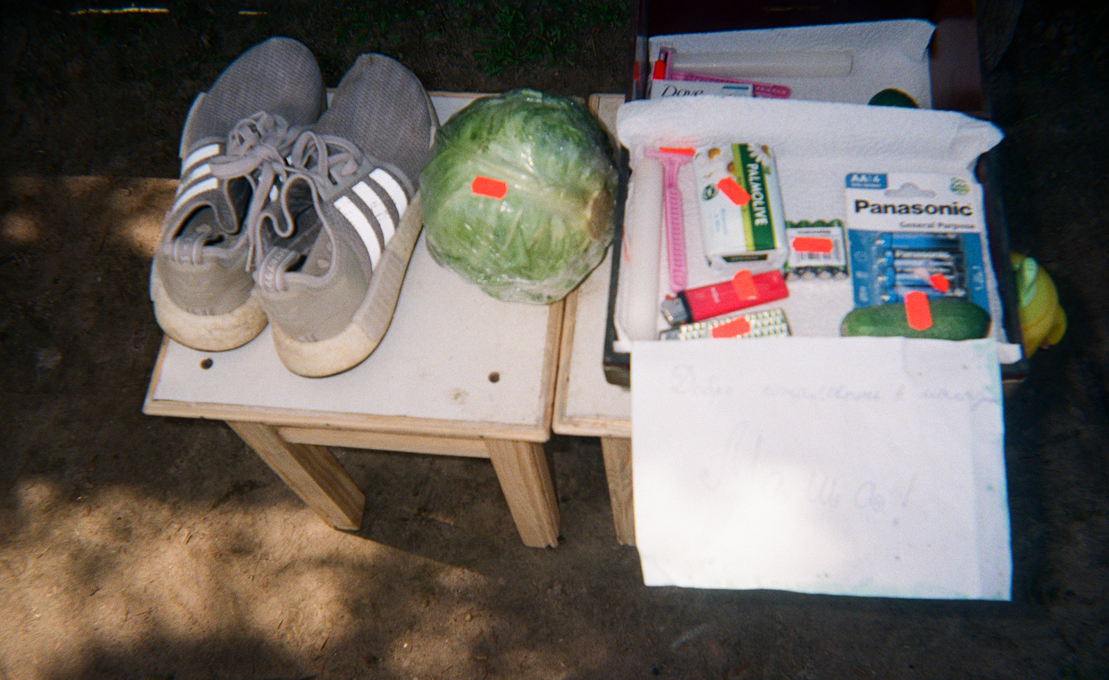 trainers, lettuce and open box on stools