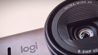 A Graphite-coloured Logitech MX Brio webcam sitting on top of a monitor