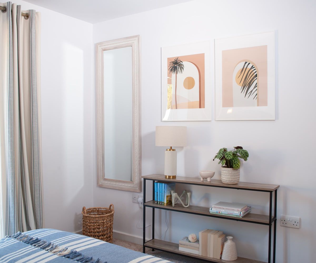 A side table and shelving in a bedroom