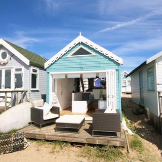 beach hut with wooden flooring and sky