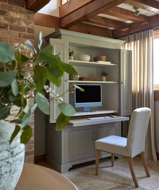 taupe coloured office bureau with doors open and cream desk chair in front of pull out desk