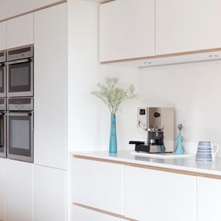 A white kitchen with a built-in oven