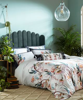 Teal green bedroom with floral duvet by Ted Baker. Image supplied by Fishpools