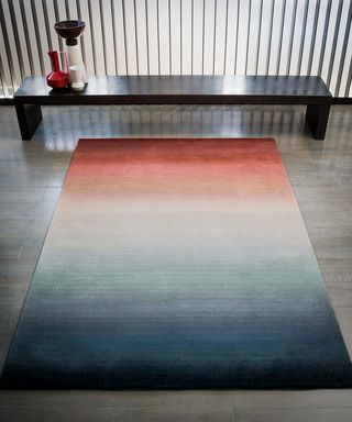 Deirdre Dyson carpet art rug with bench behind
