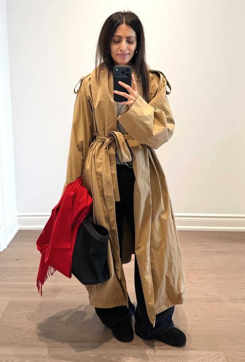 Neelam Ahooja wears a camel trench coat, baggy jeans, black boots and bag and a red scarf
