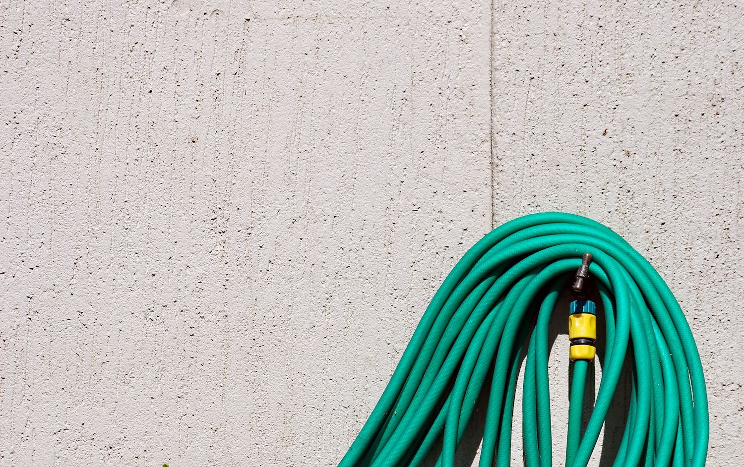 garden hose around an outdoor tap