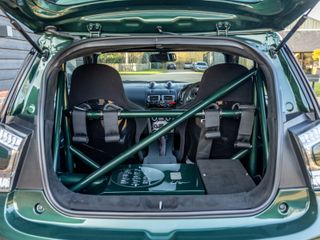 The interior features racing seats and a roll cage