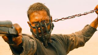 Max Rockatansky (Tom Hardy) holding a shotgun wearing a muzzle in a scene from George Miller's "Mad Max: Fury Road"