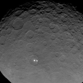 Scientists say the white spots on the dwarf planet Ceres are definitely reflecting sunlight. This wide view of the strange Ceres features was captured by NASA's Dawn spacecraft on May 16, 2015.