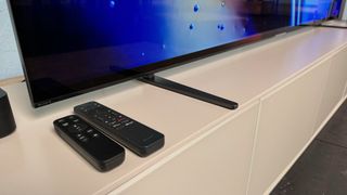 Close-up of the Sony Bravia 8's feet and remote controls