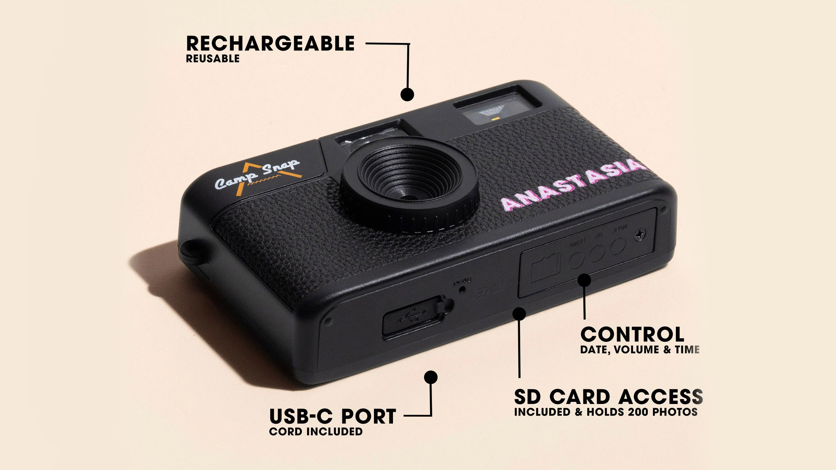 A studio shot of the Camp Snap Custom on its back and shot at three-quarters with arrows pointing to rechargeable battery, USB-C port, SD Card Access and Control for Date, Volume and Time