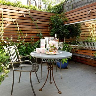 patio with wooden fence metal teacup