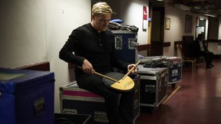 Pro drummer Craig Blundell warms up backstage on his practice pad