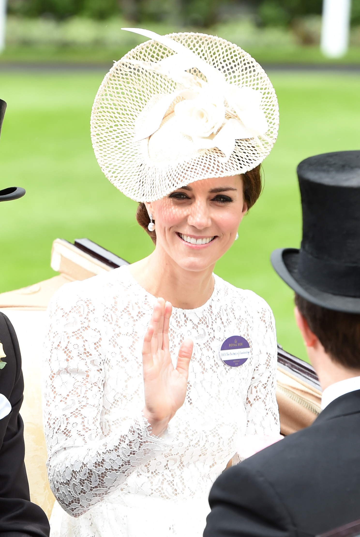 Princess Kate wearing a white lace dress waving in a carriage at Royal Ascot 2016