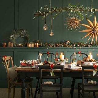 Dining table with Christmas decorations and hanging stars