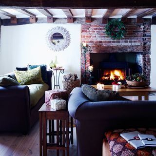 living area with fireplace and blue sofa and cushions and wooden floor