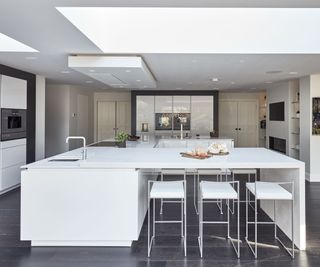 A square kitchen island merged with a u-shaped design to maximise functionality