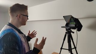 Man presenting to camera and reading from the Elgato Prompter