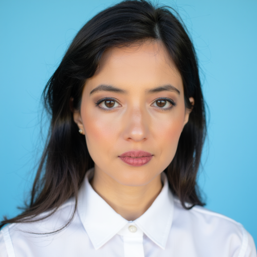 Mia is a woman of color, and presents as someone with Middle Eastern heritage. She has long dark brown hair and is pictured against a sky blue background