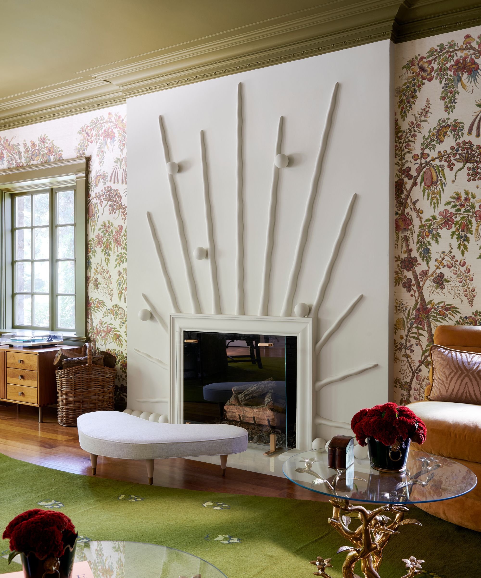 Living room with statement fireplace on a white white, the walls eitherside are decorated with wallpaper and the ceiling is painted in a dark olive green