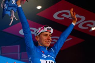 Team UAE's Slovenian rider Tadej Pogacar celebrates the best climber's blue jersey on the podium of the 11th stage of the 107th Giro d'Italia cycling race, 207km between Foiano di Val Fortore and Franca Villa al Mare, on May 15, 2024. (Photo by Luca Bettini / AFP)